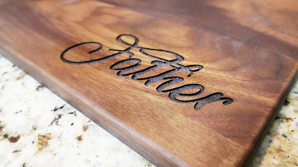 http://www.haileyhome.com/cdn/shop/products/father-engraved-walnut-cutting-board-11-x-16-918477_1200x1200.jpg?v=1628782309